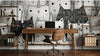 Bureau créatif habillé d'un papier peint chat noir et blanc aux motifs ludiques associant des silhouettes de chats géométriques à des éléments décoratifs comme des pelotes de laine et des étoiles