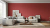 Mur intérieur d'un salon moderne entièrement recouvert de Papier Peint Rouge Terrecotta Texturé, baigné d'une lumière dorée qui accentue chaque relief mat