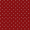 Rouleau de Papier Peint Rouge à Pois Blancs élégant déroulé sur une table en bois, révélant son motif graphique contrasté et moderne