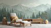 Papier Peint Panoramique Montagne Brume Vert dépeignant des sommets majestueux enveloppés d'une brume émeraude douce et mystérieuse sur un grand mur de salon moderne