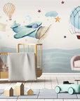 Child's wallpaper with airplanes and hot air balloons over the ocean