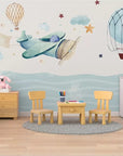 Child's wallpaper with airplanes and hot air balloons over the ocean